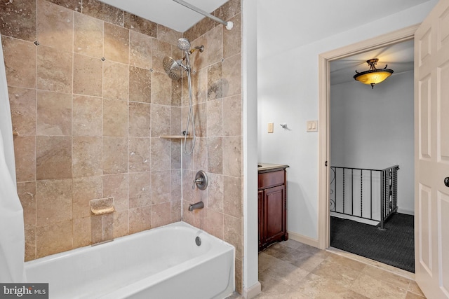 bathroom with vanity and tiled shower / bath combo