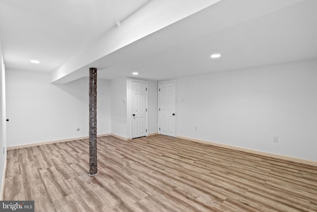 basement with light hardwood / wood-style floors