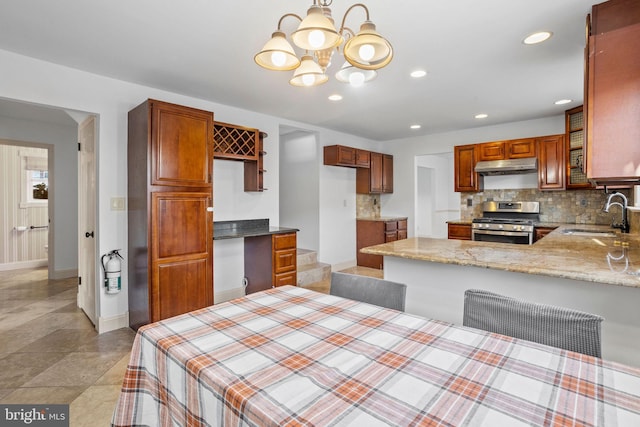 dining space with a notable chandelier and sink