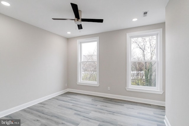 spare room with ceiling fan and light wood-type flooring