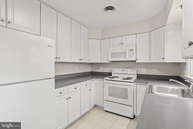 kitchen with white cabinetry, white appliances, sink, and light tile patterned floors