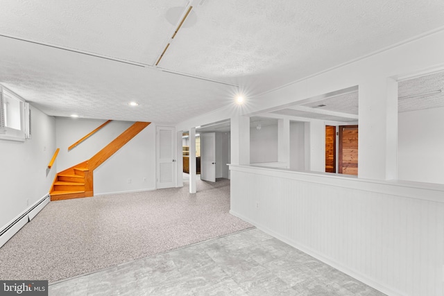 basement with baseboard heating and a textured ceiling