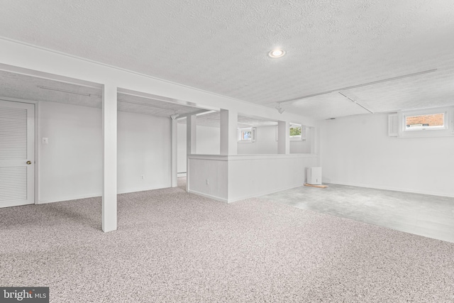 basement with carpet and a textured ceiling