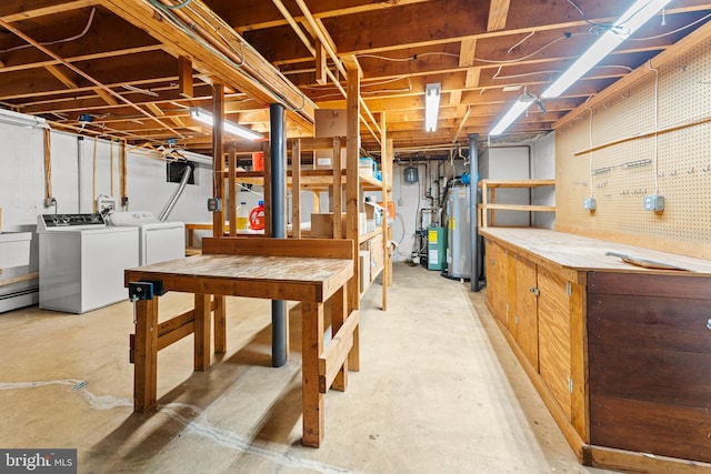 basement featuring a workshop area, washer and dryer, and gas water heater