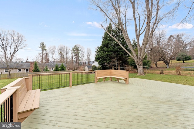 wooden terrace featuring a yard