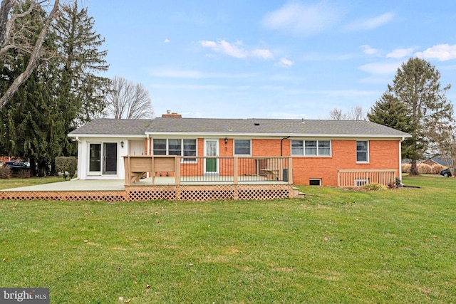 back of property featuring a yard and a deck