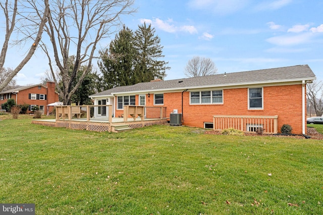 rear view of property with central AC, a yard, and a deck