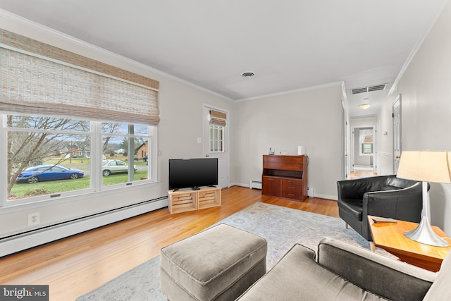 living room featuring wood-type flooring, crown molding, and a baseboard heating unit