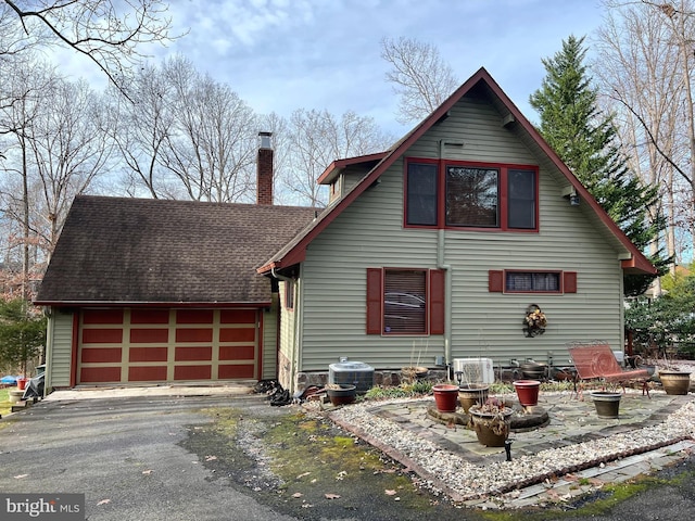 exterior space featuring a garage and central AC unit