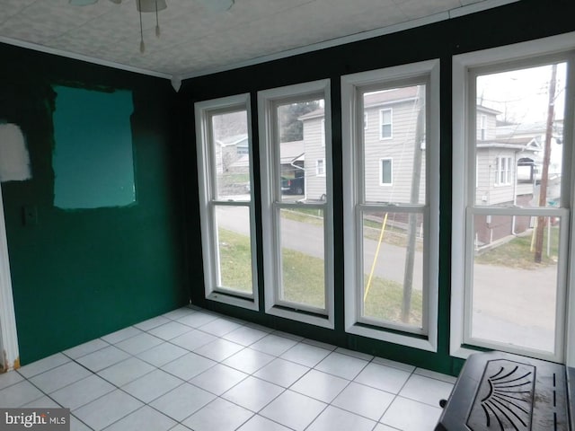 doorway with a wealth of natural light and light tile patterned flooring