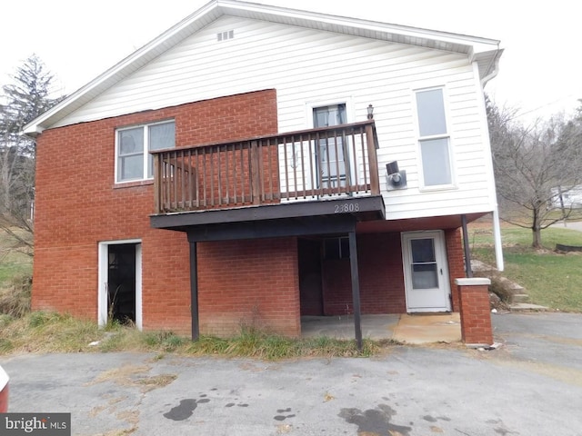 rear view of property featuring a balcony