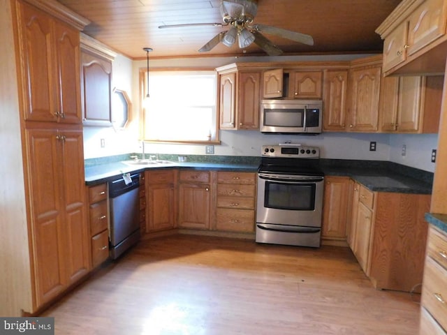 kitchen featuring ceiling fan, sink, pendant lighting, light hardwood / wood-style floors, and appliances with stainless steel finishes