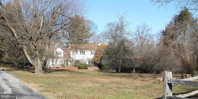 view of front of home with a chimney and a front yard