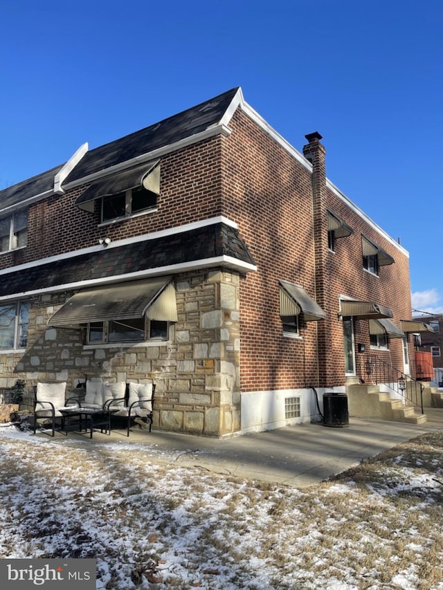 snow covered property with cooling unit