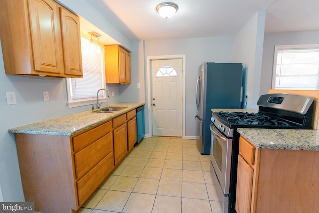 kitchen featuring sink, light tile patterned flooring, light stone countertops, and appliances with stainless steel finishes