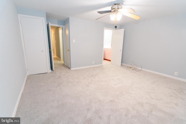 unfurnished bedroom featuring light carpet and ceiling fan