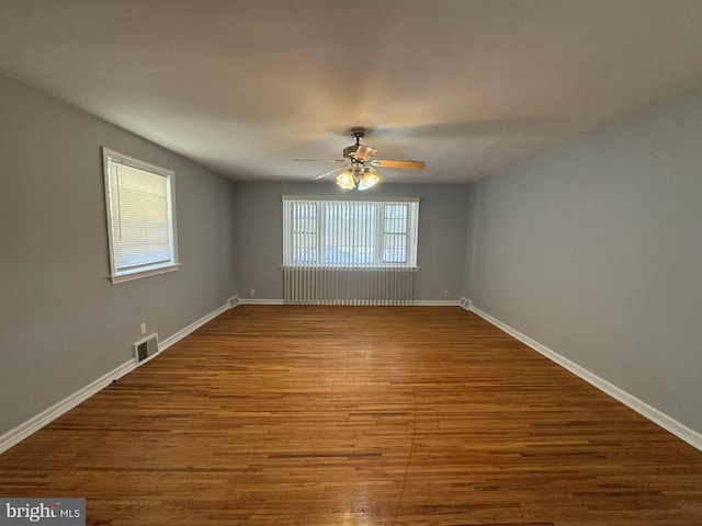 spare room with ceiling fan and wood-type flooring