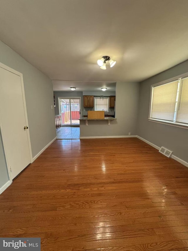 unfurnished living room featuring dark wood-type flooring