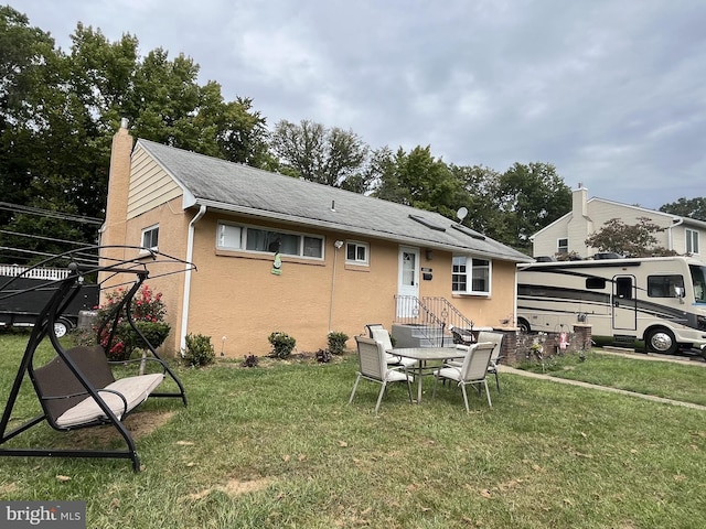 back of house with a yard