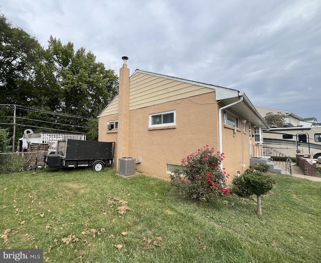 view of property exterior featuring a lawn and cooling unit