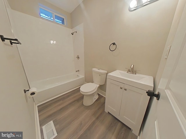 full bathroom with vanity, shower / washtub combination, hardwood / wood-style floors, and toilet