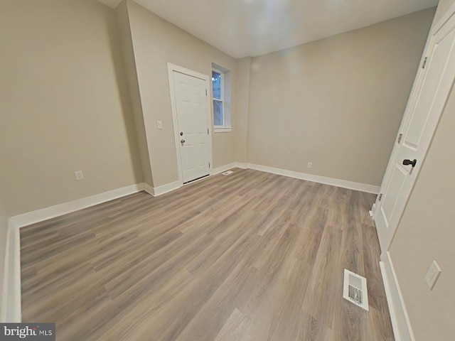 unfurnished room with light hardwood / wood-style floors