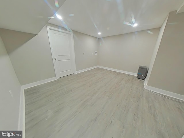 basement with light hardwood / wood-style floors