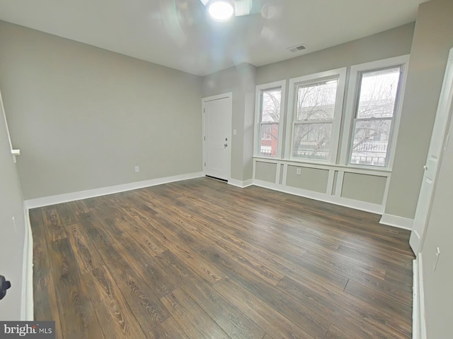 empty room featuring dark hardwood / wood-style flooring