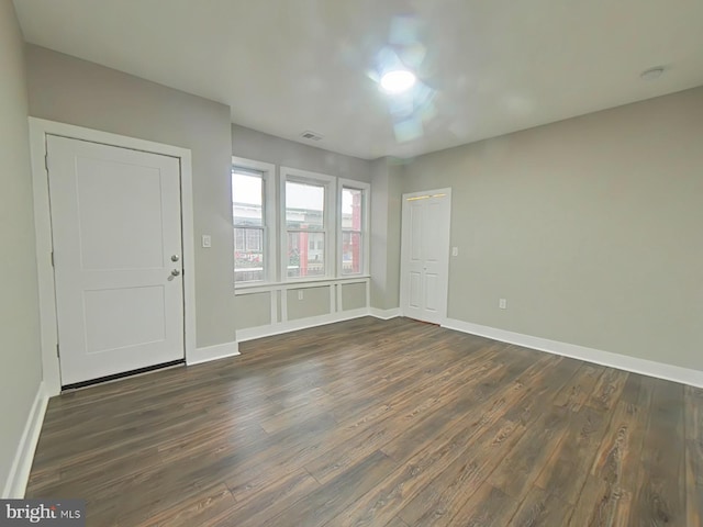 empty room with dark wood-type flooring