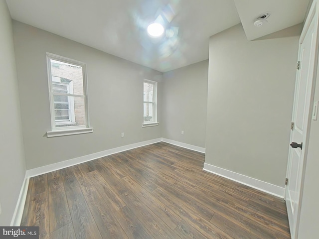 empty room with dark hardwood / wood-style floors