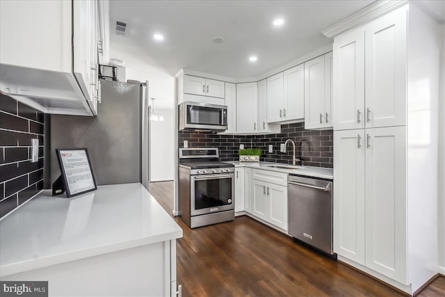 kitchen featuring sink, white cabinets, dark hardwood / wood-style floors, and appliances with stainless steel finishes