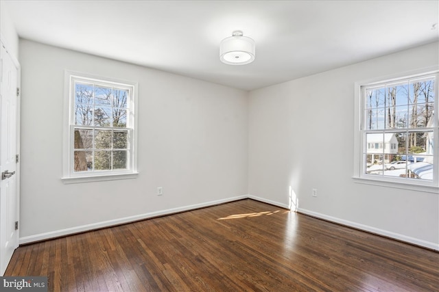 spare room with dark hardwood / wood-style flooring