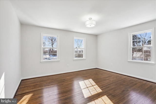 unfurnished room with dark hardwood / wood-style floors