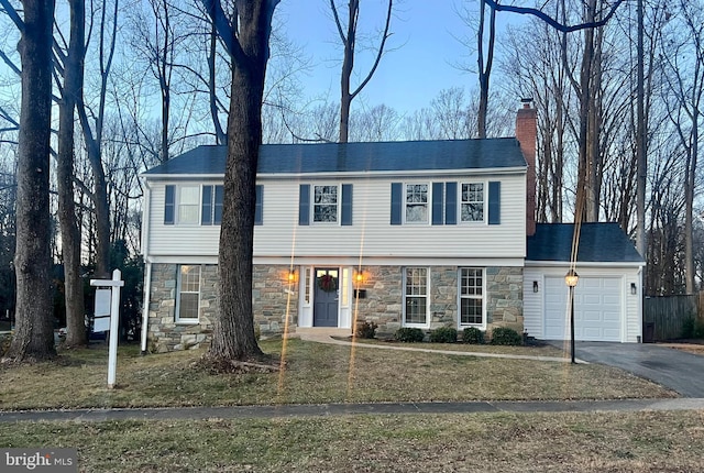 view of front facade with a front yard and a garage