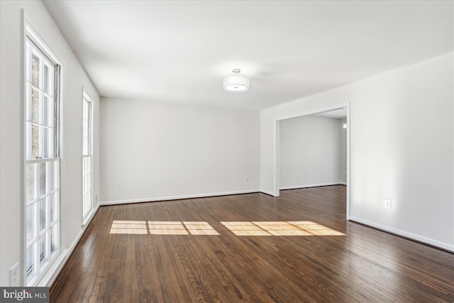 spare room featuring dark wood-type flooring