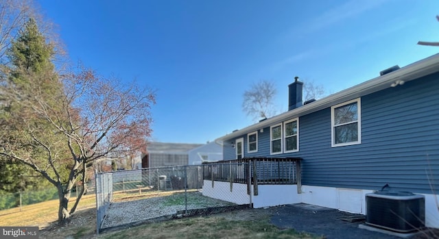 exterior space featuring fence and central air condition unit