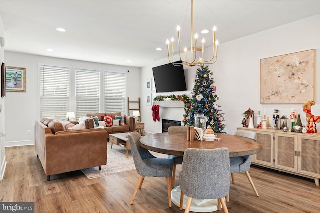 dining room featuring an inviting chandelier and light hardwood / wood-style flooring