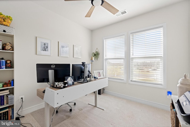 carpeted office space with ceiling fan