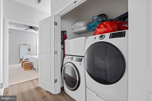 clothes washing area with ceiling fan and light hardwood / wood-style flooring