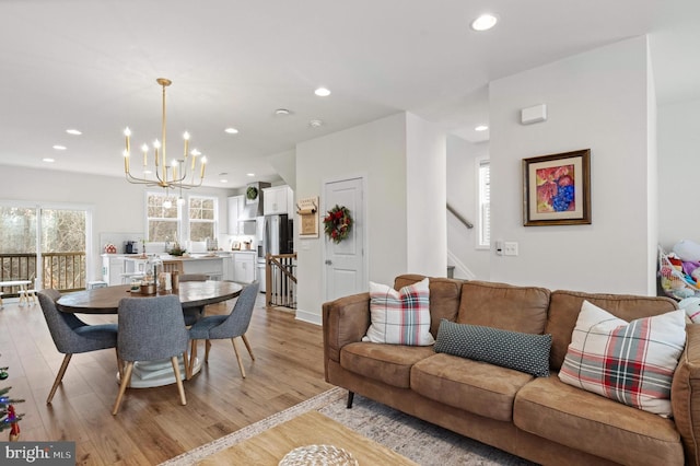 living room featuring a chandelier and light hardwood / wood-style flooring