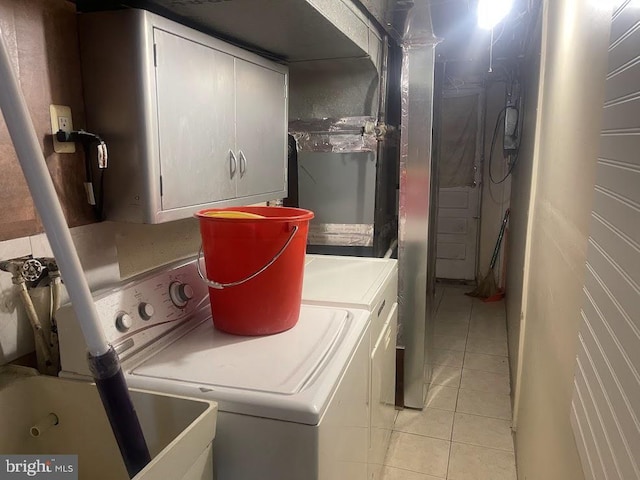 washroom featuring light tile patterned floors, cabinets, and independent washer and dryer