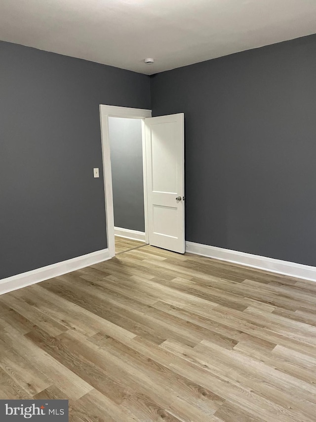 unfurnished room with light wood-type flooring