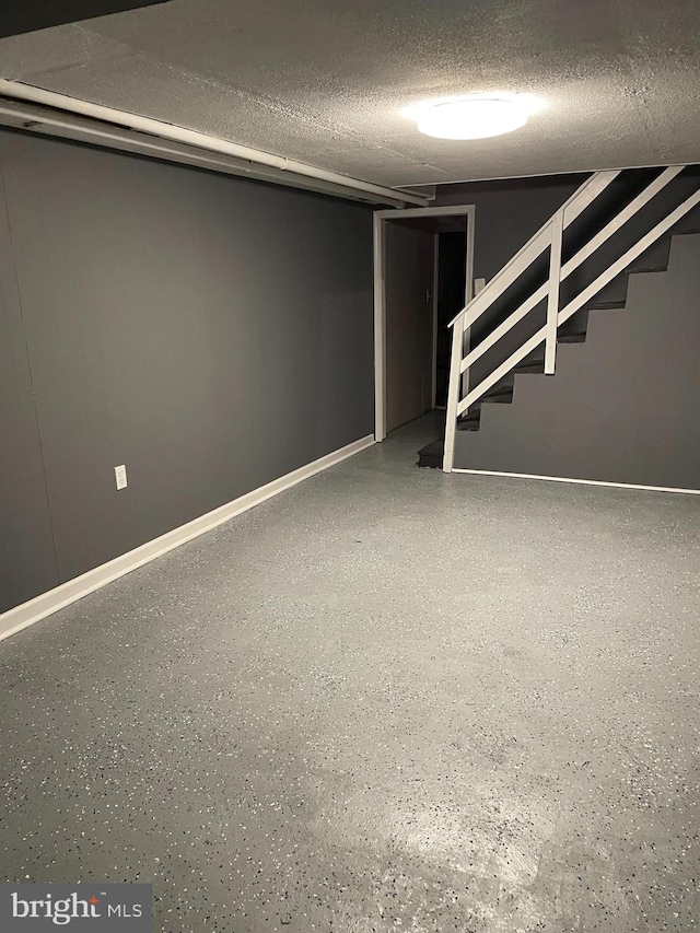 basement featuring a textured ceiling