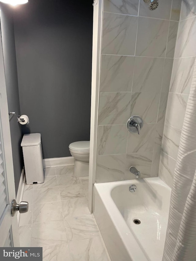 bathroom with shower / bath combo and toilet