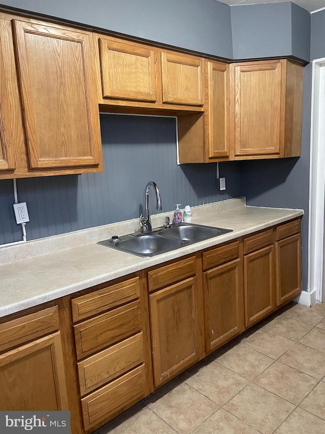 kitchen featuring sink and light tile patterned floors