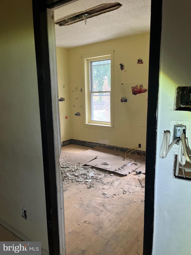 corridor with a textured ceiling