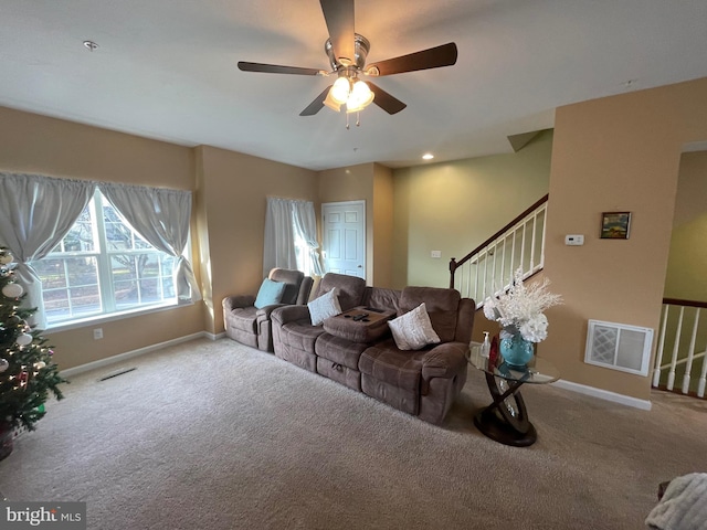 living room featuring ceiling fan and carpet