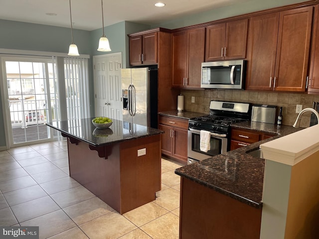 kitchen with backsplash, sink, light tile patterned floors, and appliances with stainless steel finishes