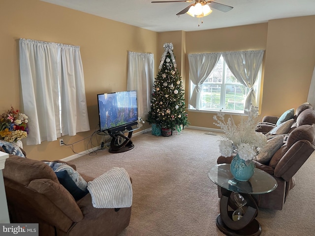 living room featuring ceiling fan and carpet