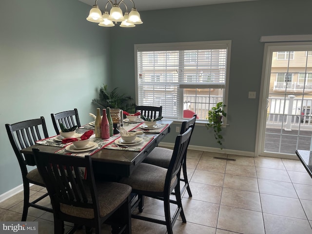 dining space with an inviting chandelier and light tile patterned flooring